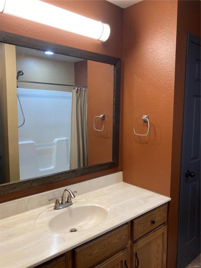Bathroom featuring vanity and a shower with shower curtain