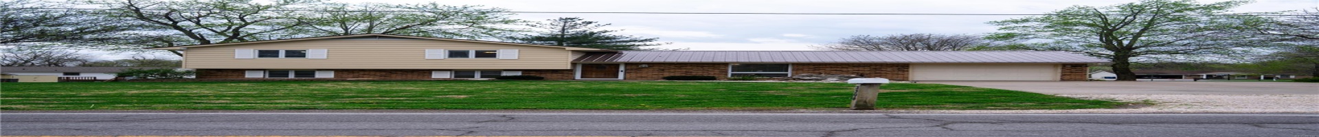 Residential For Sale Tri-level home featuring metal roof, a front yard, brick siding, a garage, and driveway