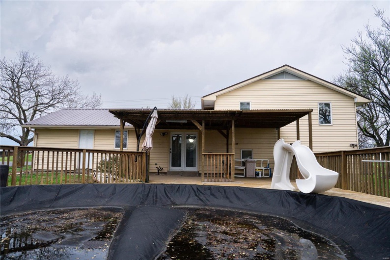 Back of house featuring french doors and a wooden deck