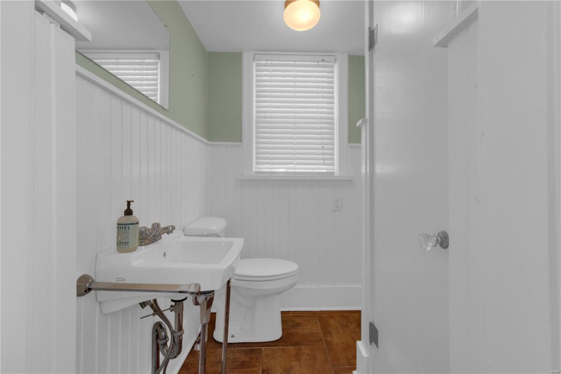 Bathroom with toilet and a wainscoted wall