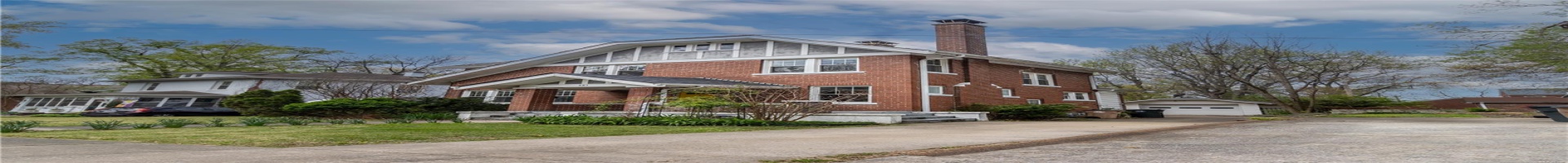 Residential For Sale View of front facade featuring an outbuilding, brick siding, a chimney, a garage, and driveway