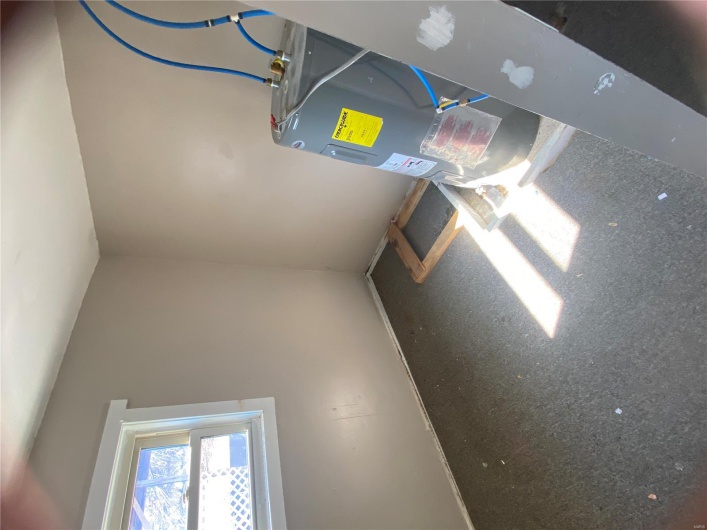 Utility room featuring water heater