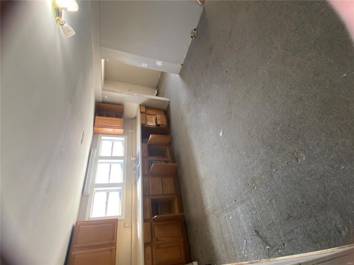 Kitchen featuring light carpet, brown cabinets, and a sink