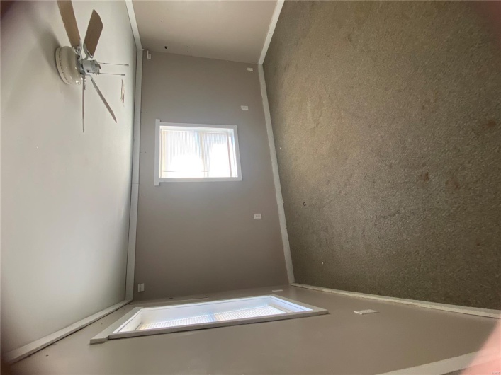 Carpeted spare room with crown molding, baseboards, and a ceiling fan