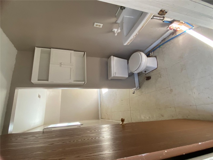 Bathroom featuring baseboards and toilet