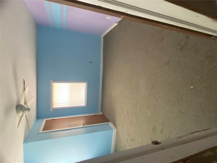 Unfurnished bedroom with a closet, carpet, baseboards, and ceiling fan