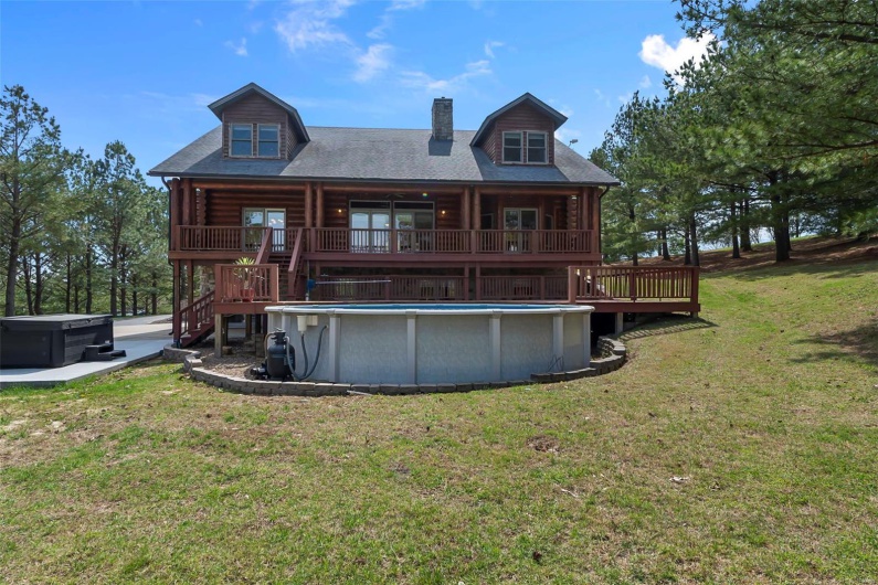 Northeast Face of Home Showcasing Pool, Premium Hot Tub, & Decks