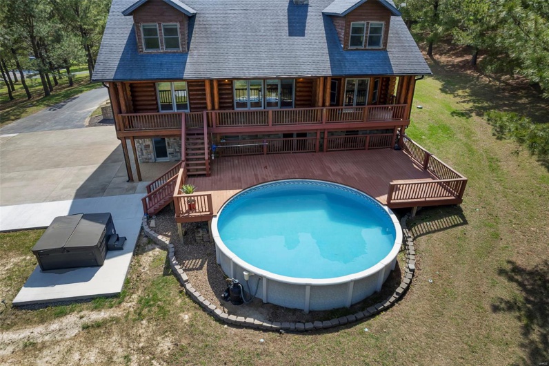 Back of Home Showcasing Pool, Patio/Deck, & Premium Hot Tub