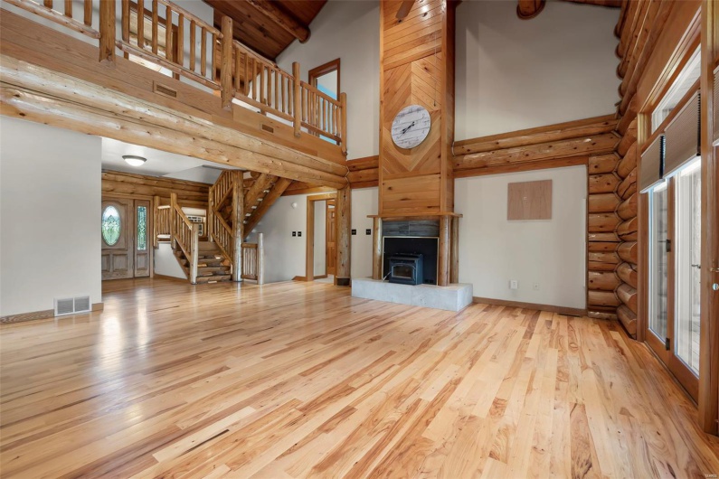 Great Room with Cathedral Ceilings, Floor to Ceiling Fireplace, and Lofted Hallway to Guest Rooms