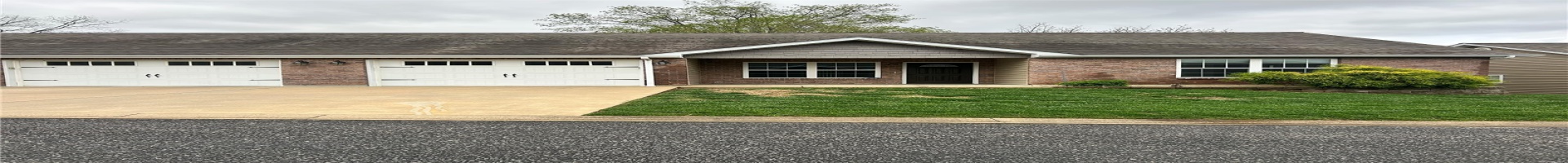 Residential For Sale View of front of house with a front lawn, roof with shingles, concrete driveway, brick siding, and a garage