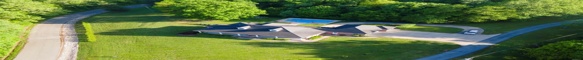 Residential For Sale Picturesque Aerial View of All Brick Custom Home with Pool & Lake Access on 5.4 Acres