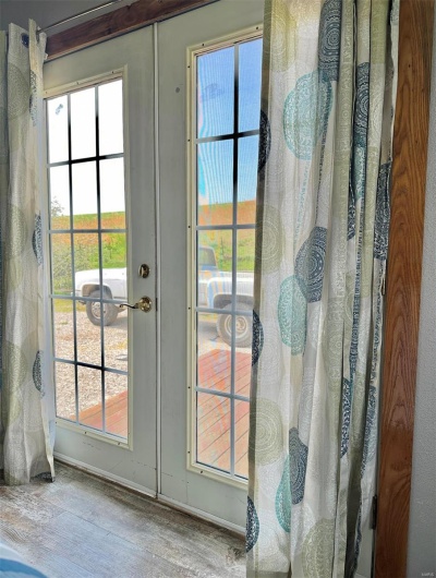 Doorway to outside with wood finished floors and baseboards