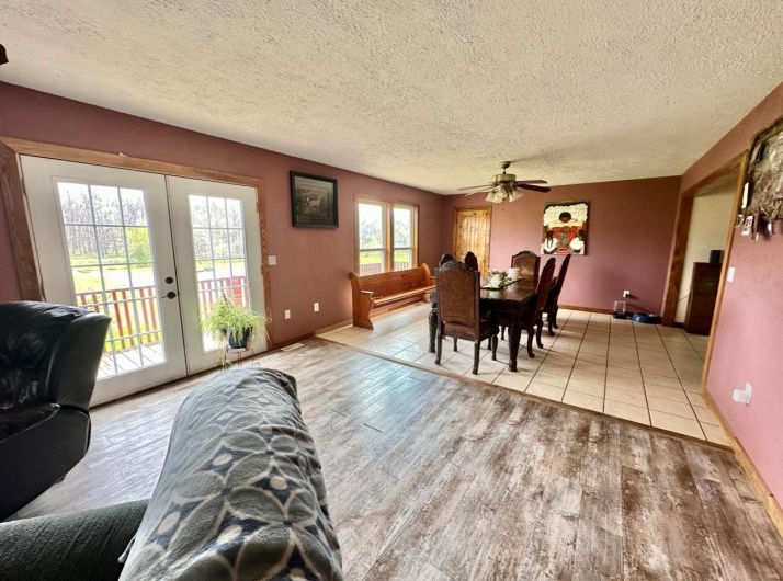 Dining room with light wood-style flooring, a textured ceiling, french doors, and ceiling fan