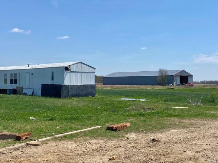 View of yard featuring an outbuilding and an outdoor structure