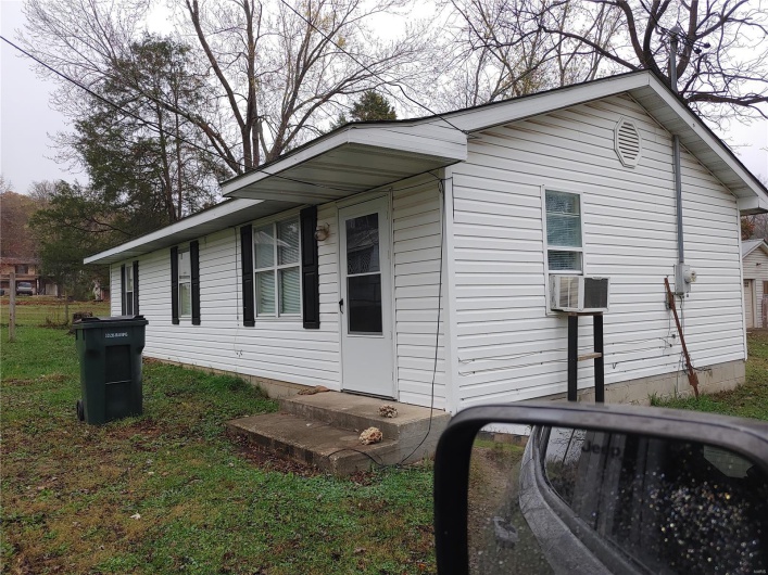 View of side of home featuring cooling unit