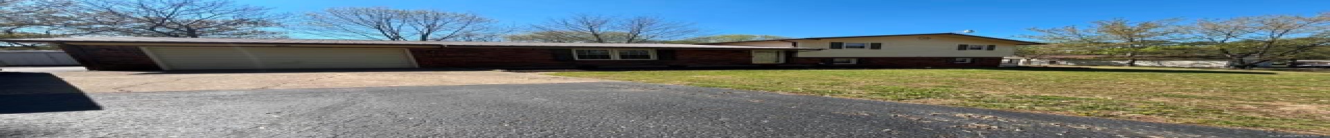 Residential For Sale Split level home featuring a front yard, an attached garage, metal roof, brick siding, and driveway