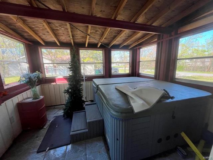 Sunroom / solarium with stone finish flooring and plenty of natural light