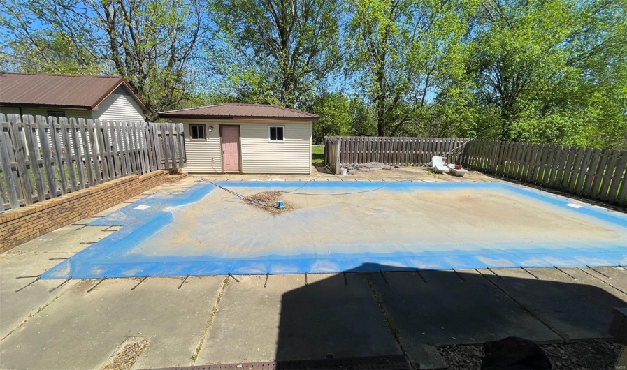 View of pool with a fenced backyard, an outbuilding, and a storage unit