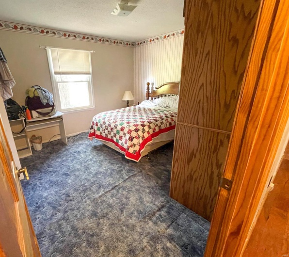 Bedroom featuring a textured ceiling and carpet flooring