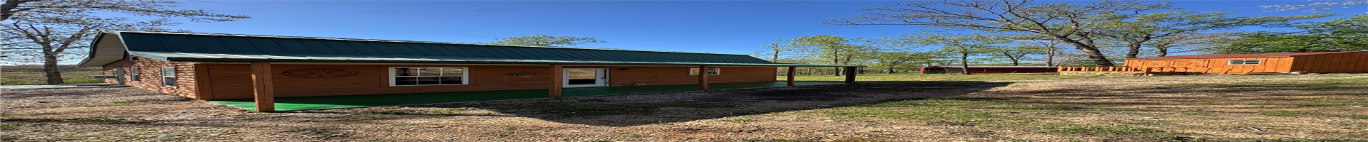Residential For Sale Back of house with an outbuilding, a standing seam roof, a storage shed, metal roof, and faux log siding
