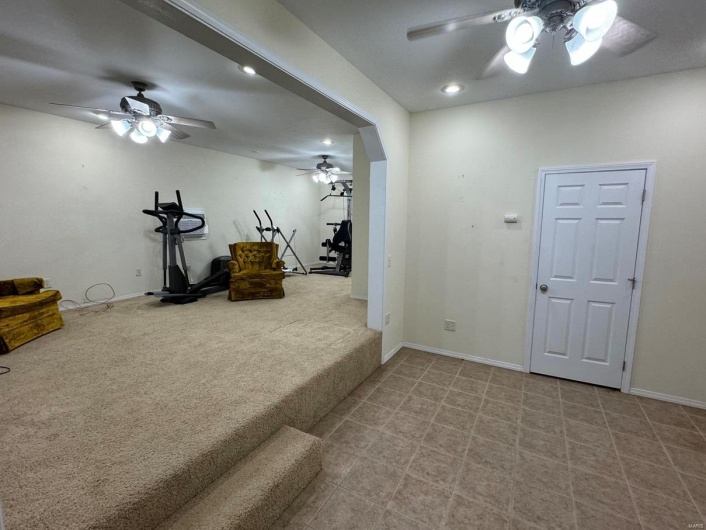 Exercise area featuring ceiling fan, baseboards, carpet flooring, and recessed lighting