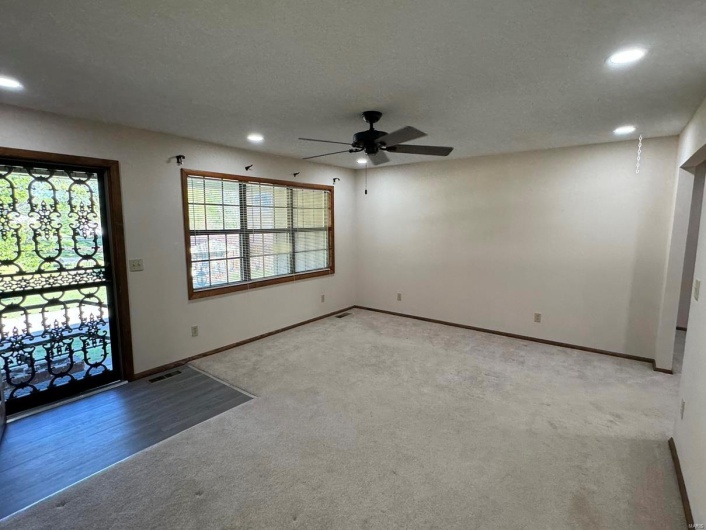 Entryway with recessed lighting, light colored carpet, baseboards, and ceiling fan