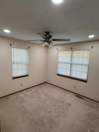 Carpeted empty room with recessed lighting, visible vents, baseboards, and a ceiling fan