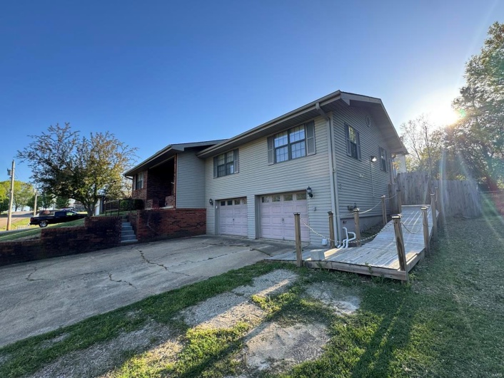 View of property exterior featuring a garage and concrete driveway