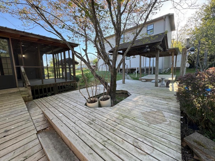 Wooden deck featuring a sunroom