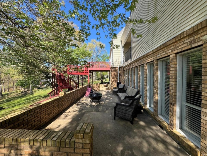 View of patio / terrace with an outdoor fire pit, a wooden deck, and stairway