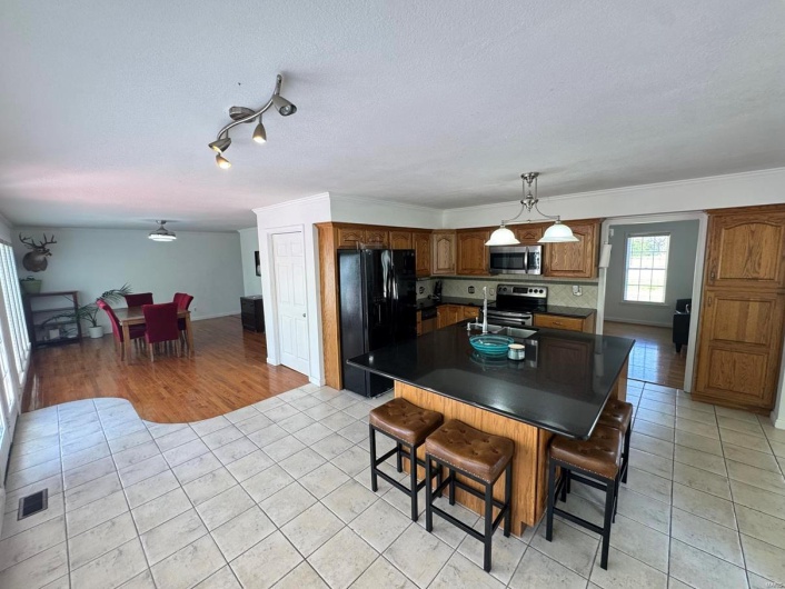 Dining space featuring a textured ceiling, light tile patterned floors, and visible vents