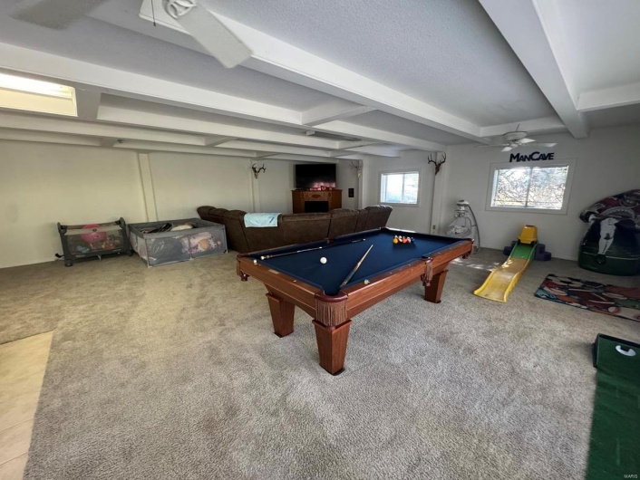 Playroom with beamed ceiling, billiards, and carpet floors
