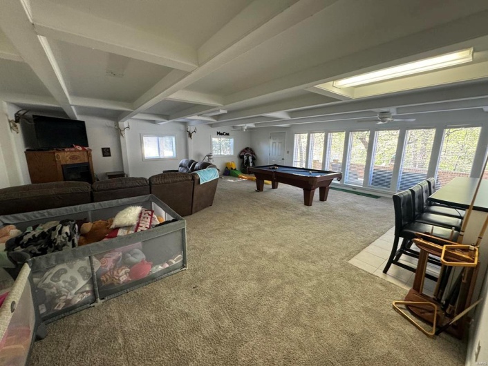 Game room featuring beamed ceiling, ceiling fan, carpet, coffered ceiling, and billiards