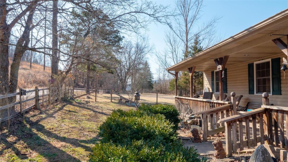 View of yard featuring covered porch and fence