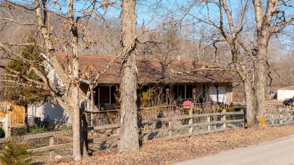 View of front of house featuring fence