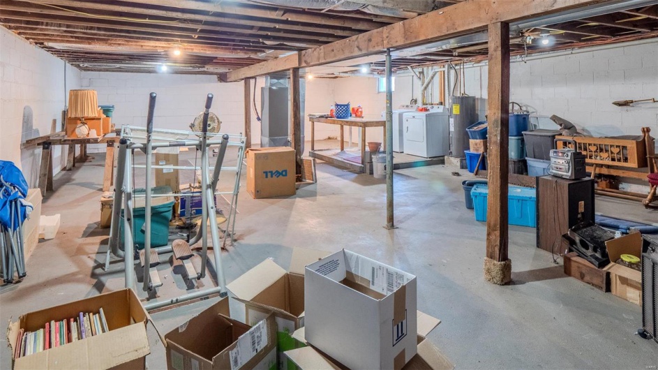 Unfinished below grade area with washer and dryer