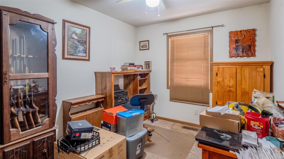 Office featuring visible vents, baseboards, ceiling fan, and carpet flooring