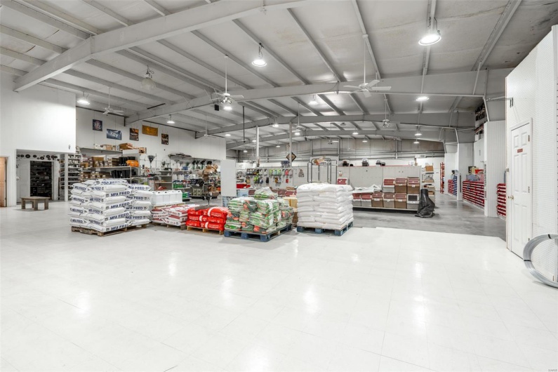 Garage featuring a ceiling fan and a workshop area