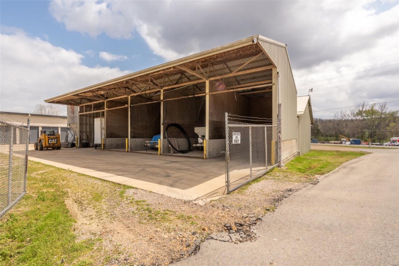 View of outdoor structure with a carport and an outbuilding