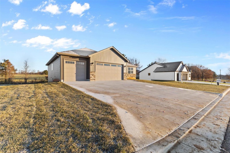 View of front facade with a front lawn and a garage