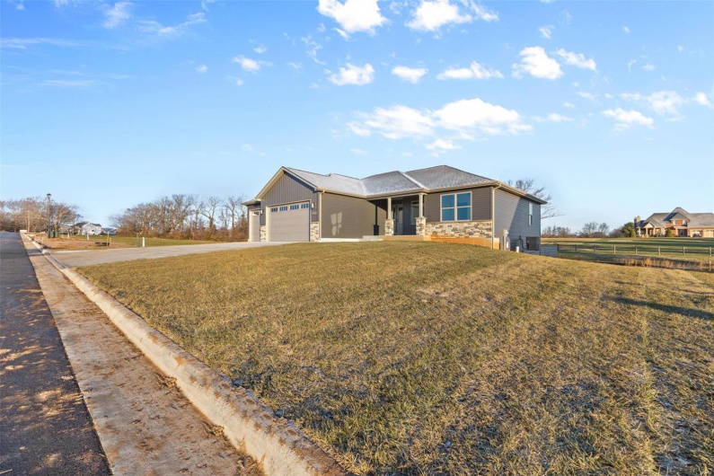 Ranch-style home featuring a garage and a front yard