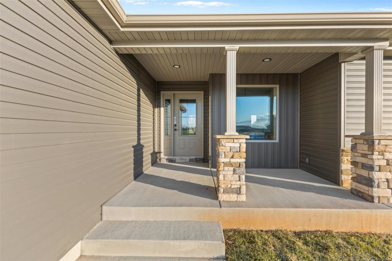 View of exterior entry with a porch