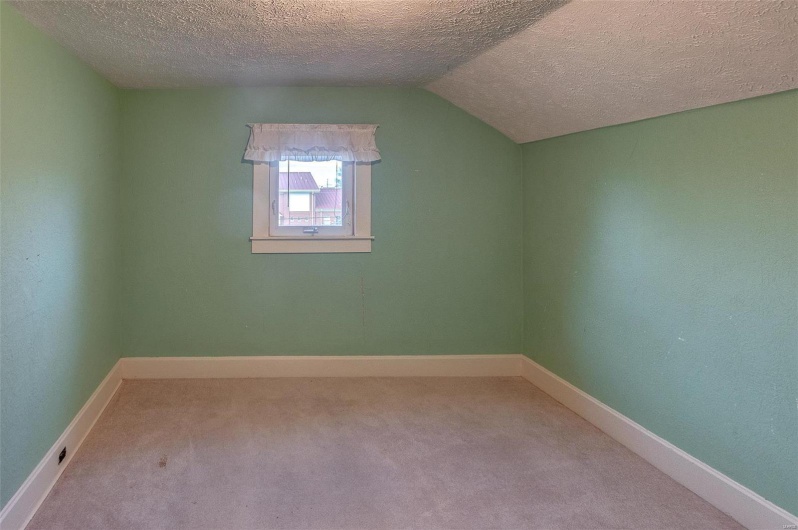 Bonus room with carpet flooring, baseboards, vaulted ceiling, and a textured ceiling