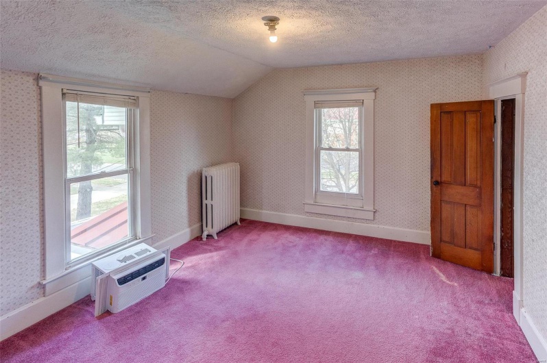 Bonus room with radiator heating unit, wallpapered walls, and carpet floors