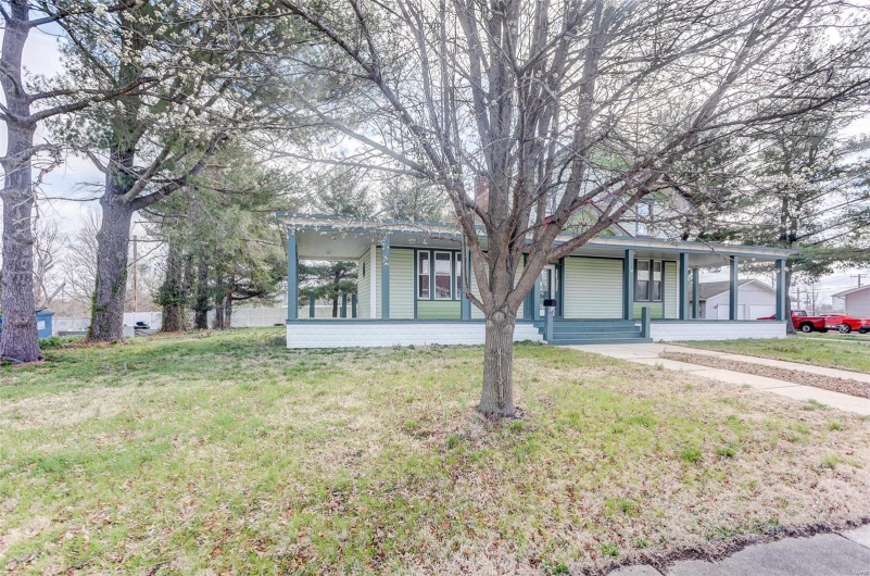 Single story home featuring a front lawn
