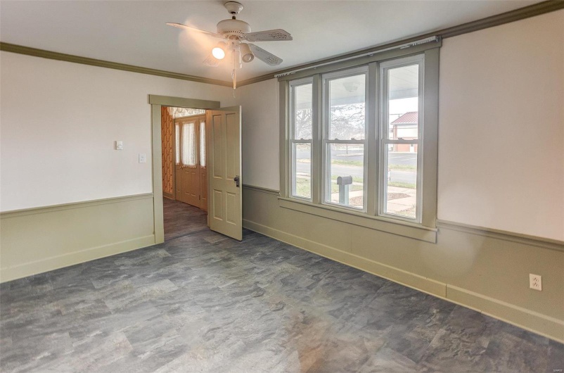 Spare room with baseboards, ornamental molding, and a ceiling fan