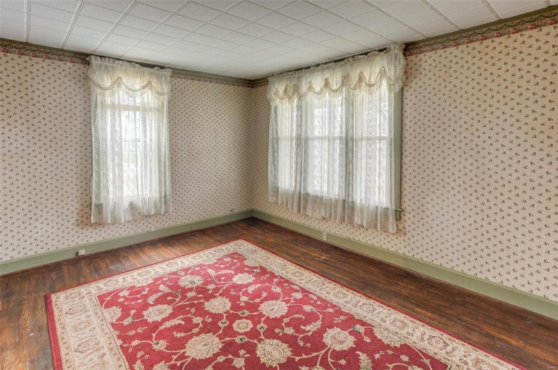 Spare room featuring hardwood / wood-style floors, wallpapered walls, and plenty of natural light