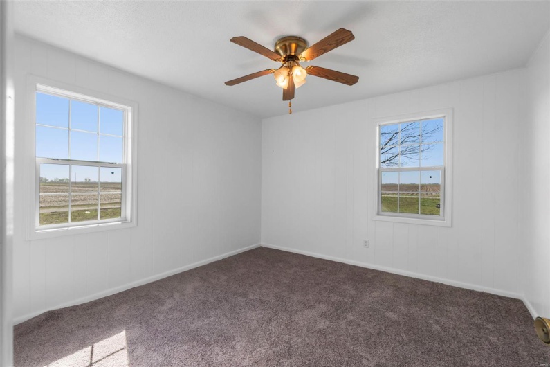 Spare room with baseboards, carpet, and ceiling fan