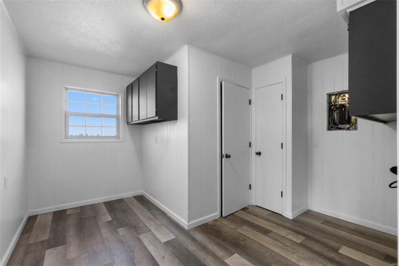 Bonus room with dark wood finished floors, a textured ceiling, and baseboards