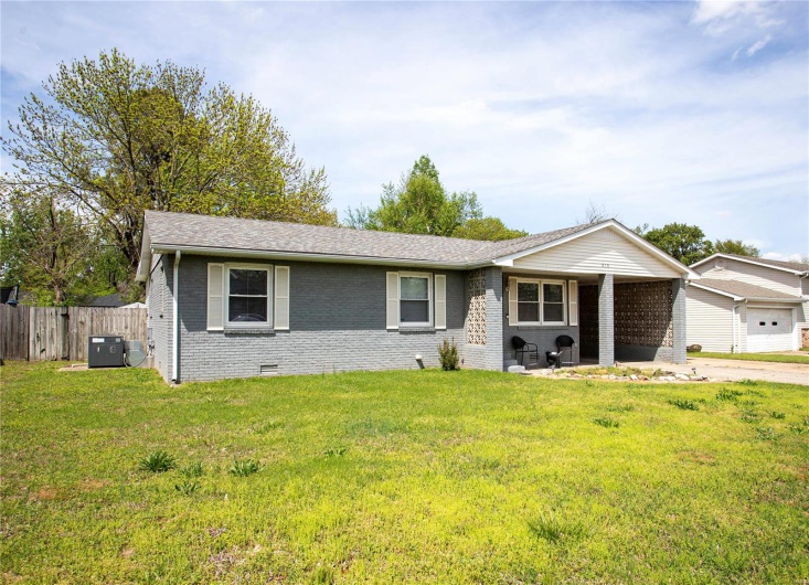 Ranch-style home featuring brick siding, crawl space, a front lawn, and fence